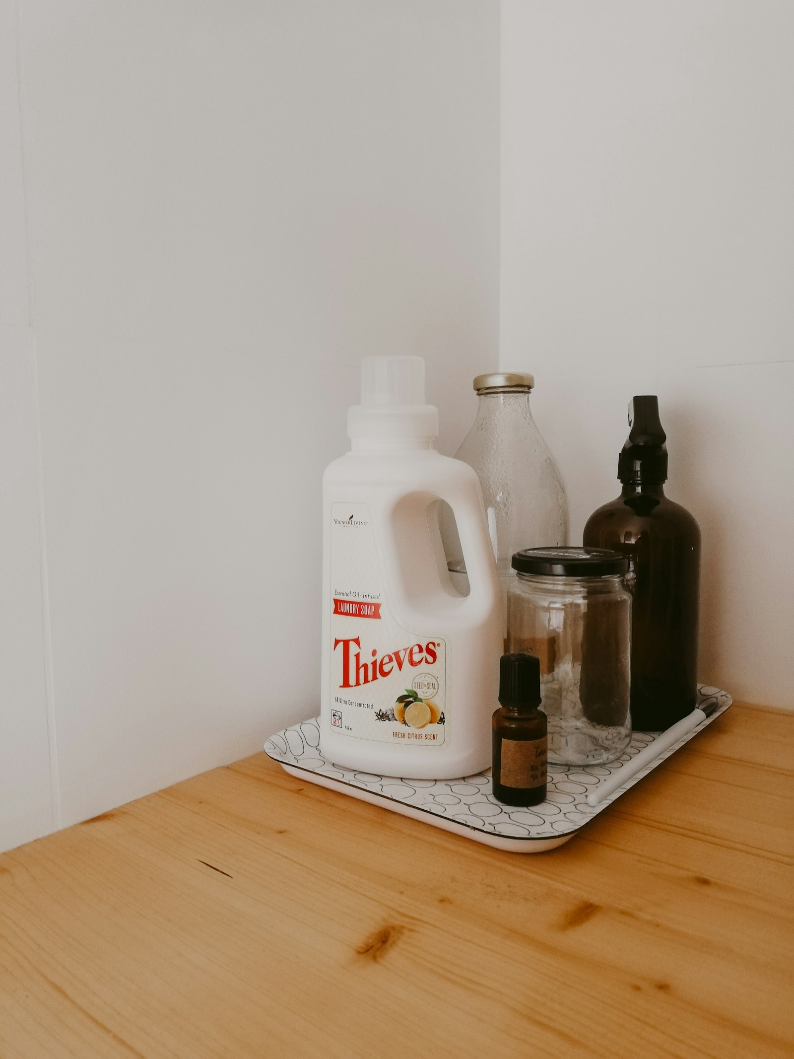 White bottle standing on a wooden table, still life