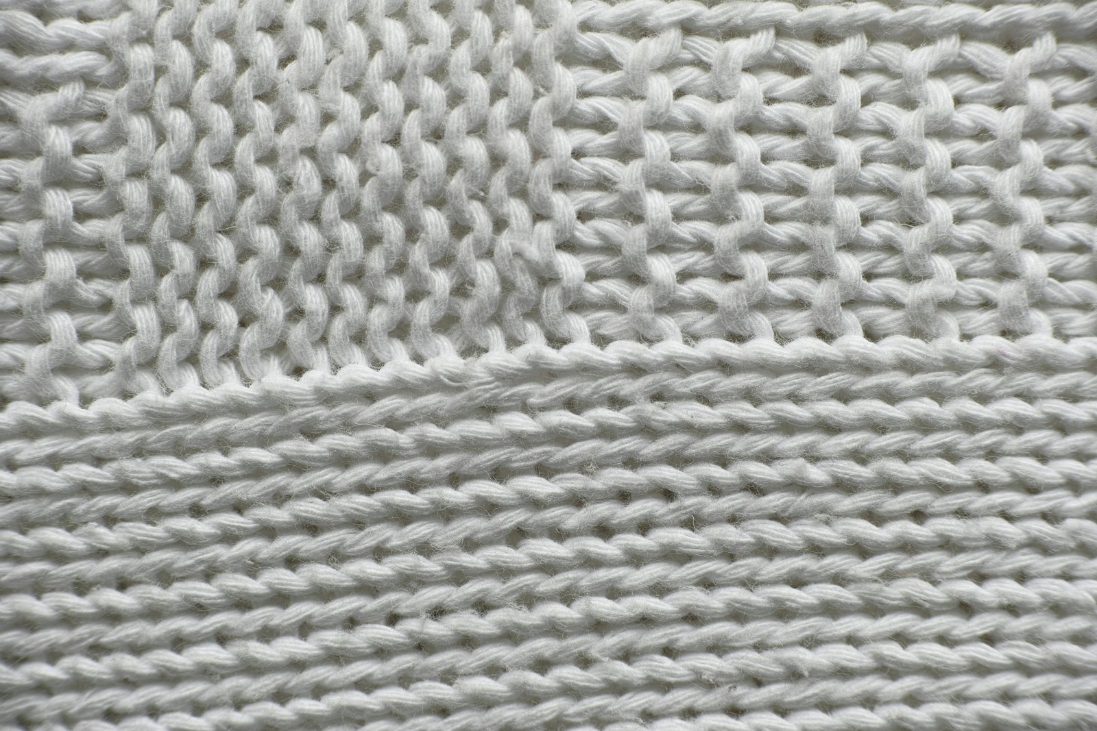 White knit fabric in close-up, the weave a soft brush protects