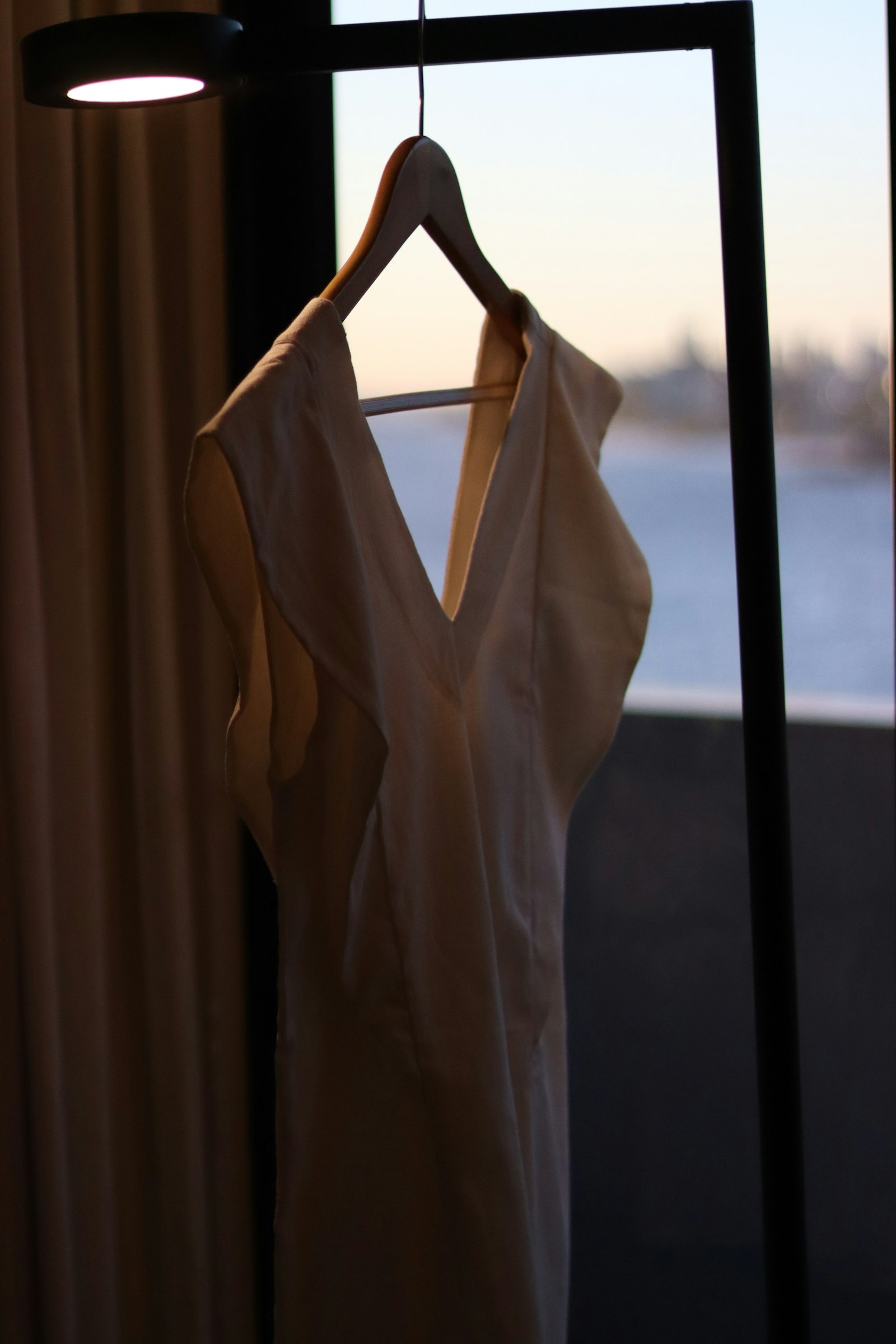 A white shirt on the rail beside a bright window