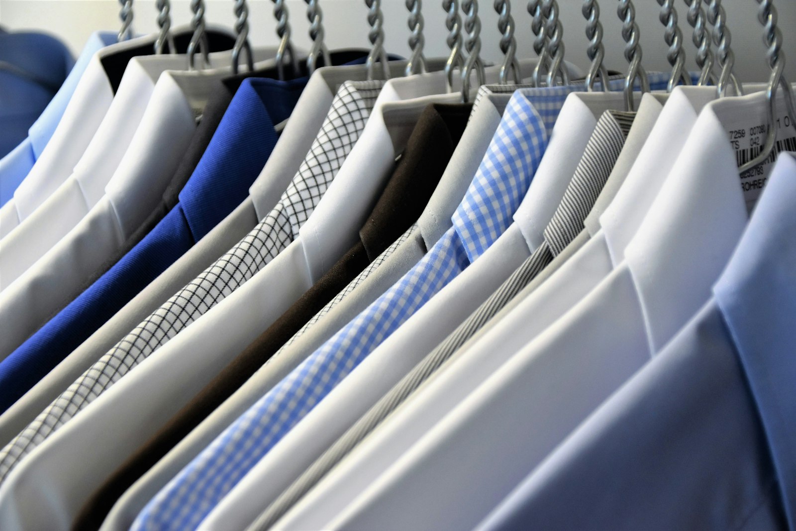 A row of pressed shirts hanging ready for delivery