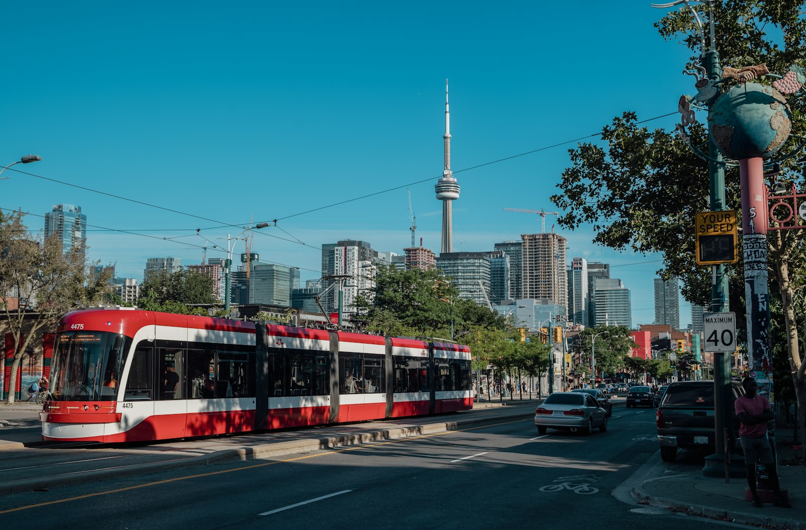 Red streetcar rolling down a Toronto street