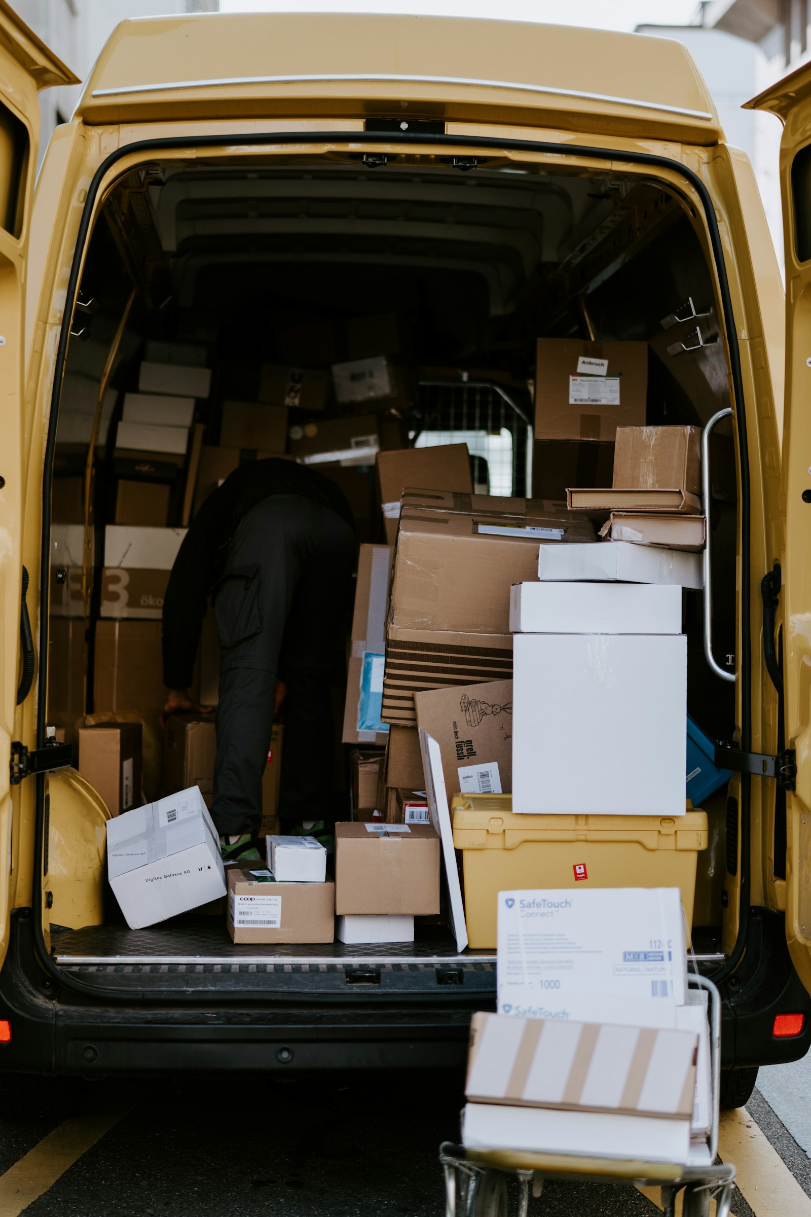 Loading garment bags into the delivery van on a route morning