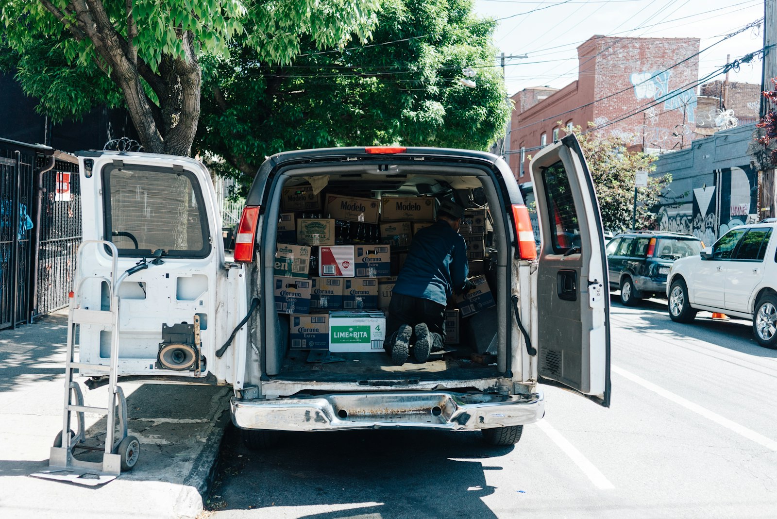 White delivery van with its doors open, loaded for the route